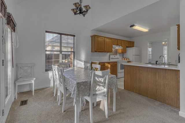 carpeted dining space with sink