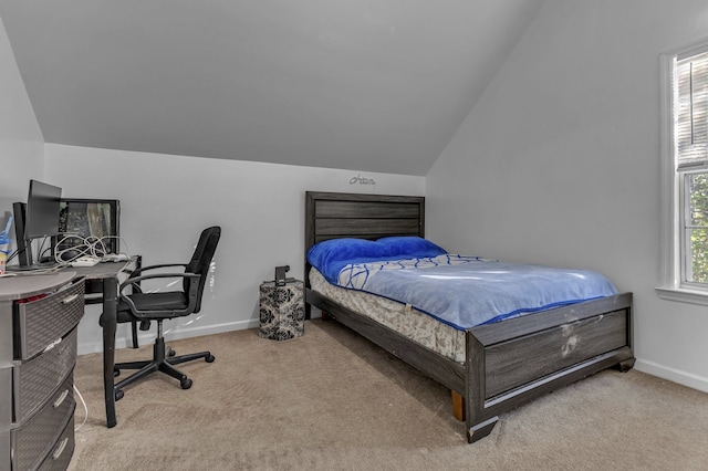 bedroom with carpet floors and lofted ceiling