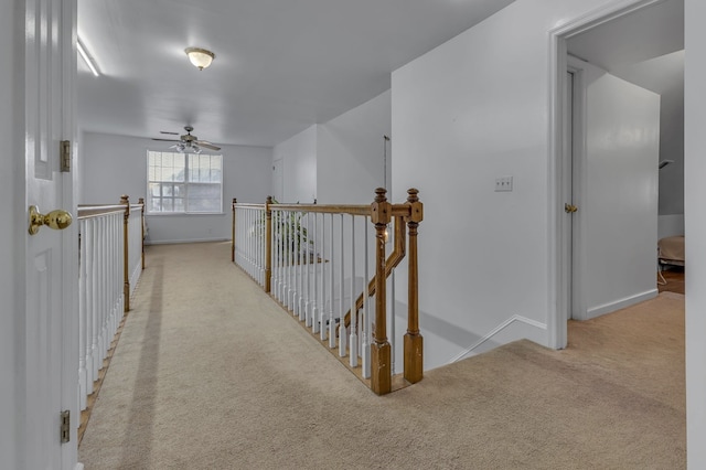 hall featuring light colored carpet