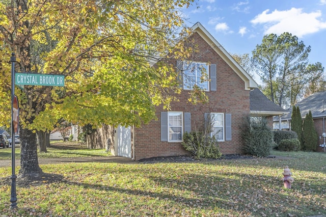 view of side of home with a garage and a yard