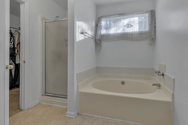 bathroom featuring shower with separate bathtub and tile patterned floors