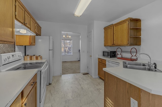 kitchen featuring backsplash, white appliances, sink, and an inviting chandelier