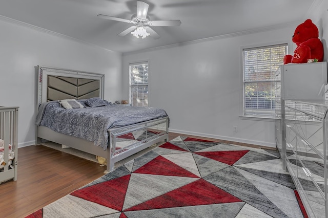 bedroom with ceiling fan, dark hardwood / wood-style flooring, and ornamental molding