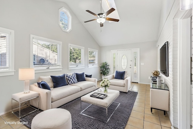 living room featuring ceiling fan, light tile patterned flooring, and high vaulted ceiling