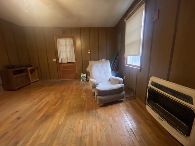 living area featuring hardwood / wood-style flooring and heating unit