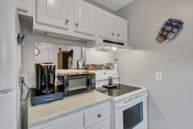 kitchen featuring white cabinets, a textured ceiling, and white appliances