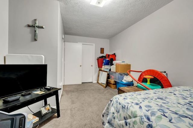 carpeted bedroom featuring a textured ceiling