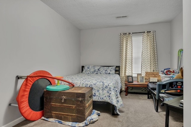 carpeted bedroom featuring a textured ceiling