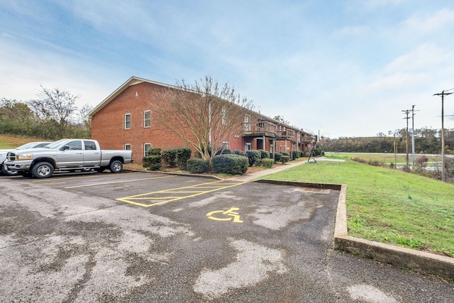 view of parking featuring a yard