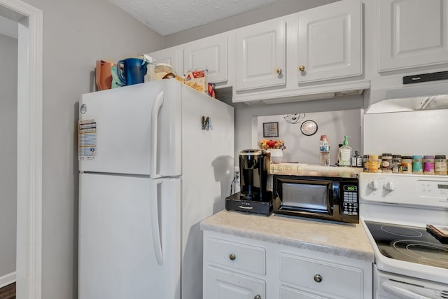 kitchen with a textured ceiling, white appliances, and white cabinetry