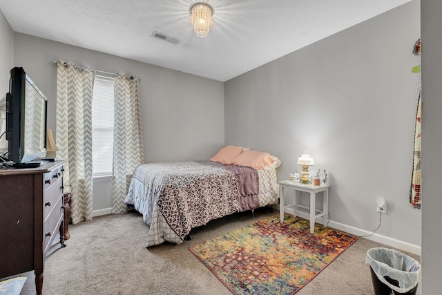 bedroom with carpet and a textured ceiling