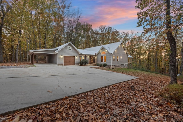 ranch-style home featuring a garage and a carport