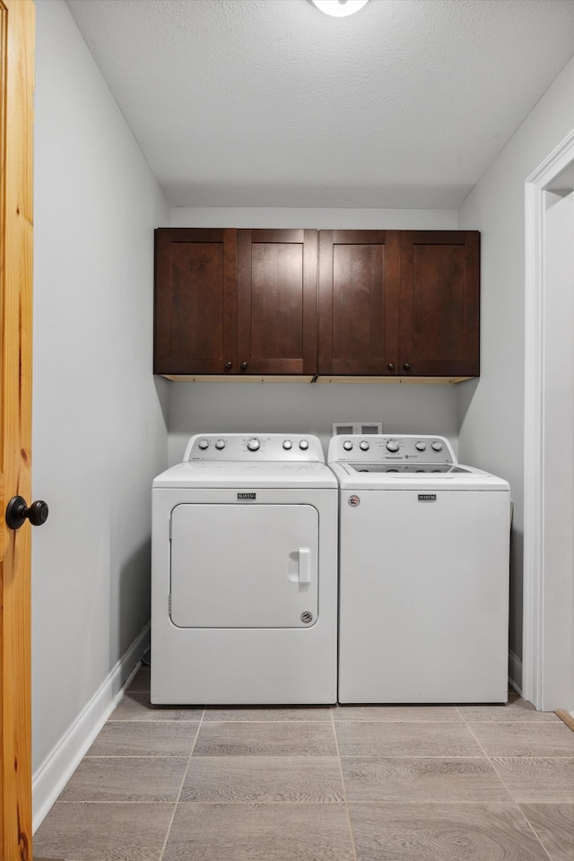 4955 Ringgold Rd, La Fayette, GA 30728 - clothes washing area with cabinets, a textured ceiling, washing machine and dryer, and light hardwood / wood-style flooring