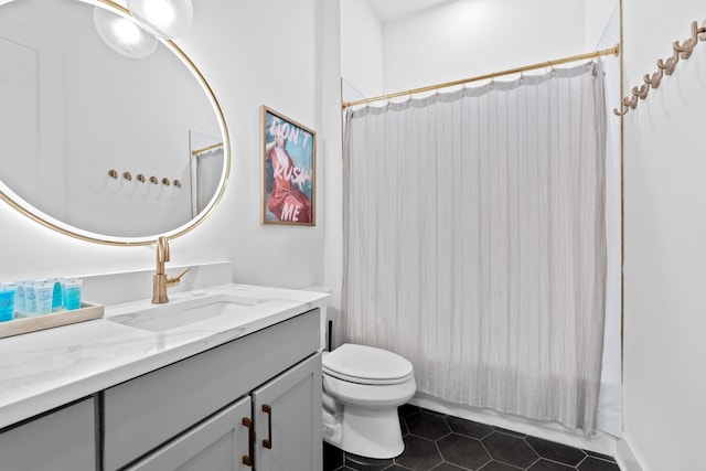 full bathroom with tile patterned flooring, vanity, toilet, and shower / bath combo with shower curtain