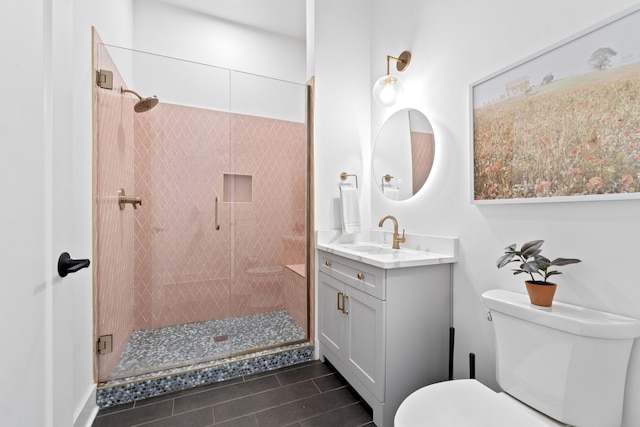 bathroom with tile patterned floors, vanity, toilet, and walk in shower