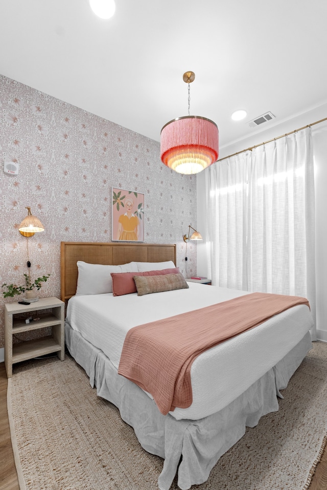 bedroom with wood-type flooring