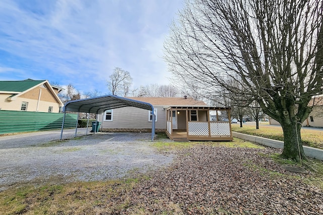 view of front of home featuring a deck and a carport