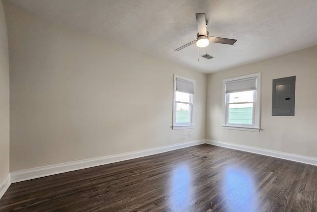 spare room featuring ceiling fan, dark hardwood / wood-style flooring, and electric panel