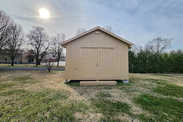 view of outdoor structure featuring a lawn