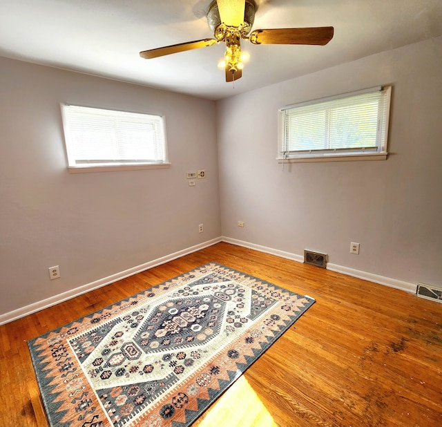 unfurnished room featuring hardwood / wood-style floors and ceiling fan