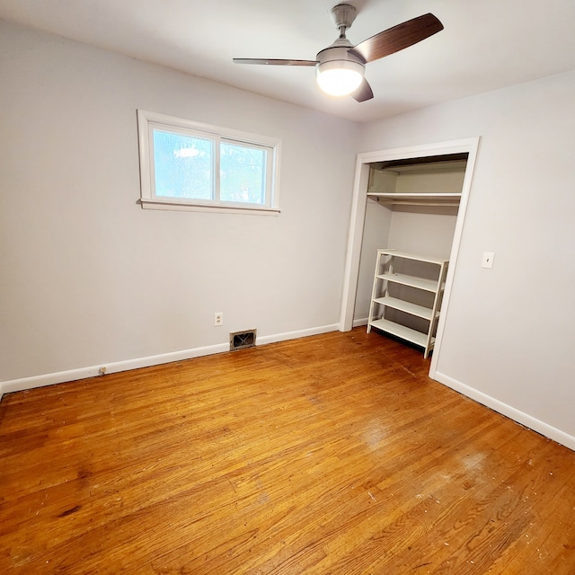 unfurnished bedroom with a closet, light hardwood / wood-style flooring, and ceiling fan