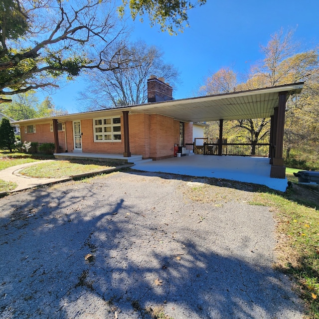 view of front facade featuring a porch and a carport