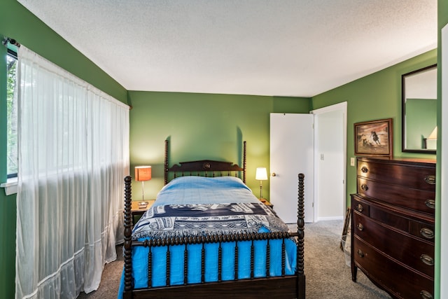 carpeted bedroom featuring a textured ceiling