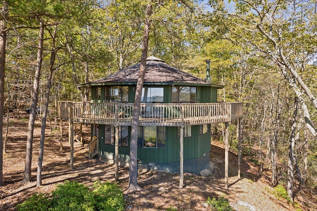 rear view of property with a wooden deck