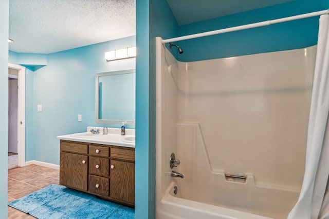 bathroom featuring tile patterned flooring, vanity, shower / bath combination with curtain, and a textured ceiling