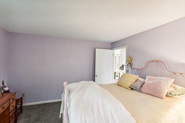 carpeted bedroom featuring a textured ceiling