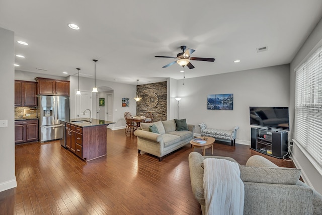 living room featuring ceiling fan, dark hardwood / wood-style flooring, and sink