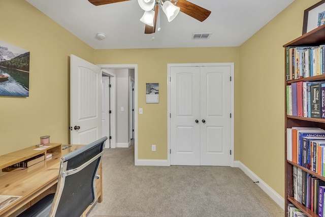 carpeted home office with ceiling fan