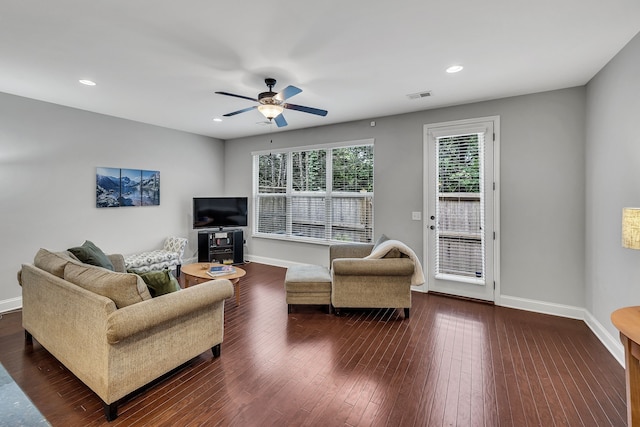 living room featuring dark hardwood / wood-style floors and ceiling fan