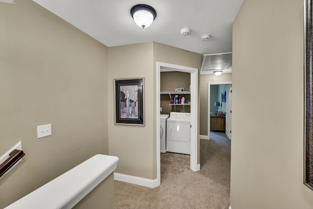 corridor featuring washer and clothes dryer and light carpet