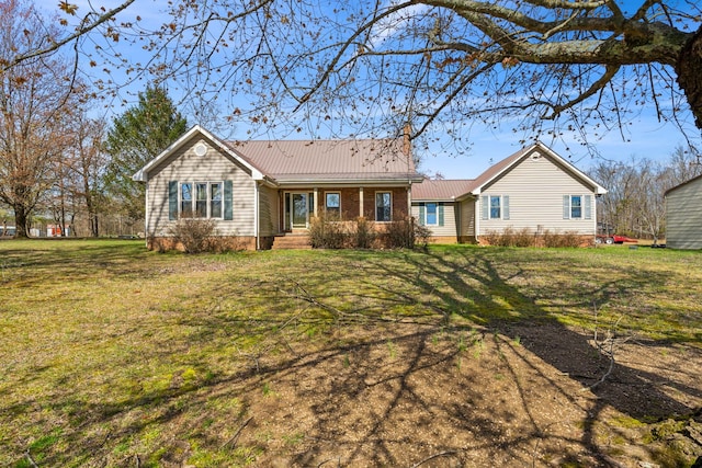 rear view of property with a lawn