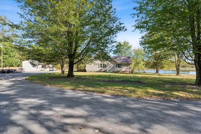 view of front facade featuring a front yard and a water view