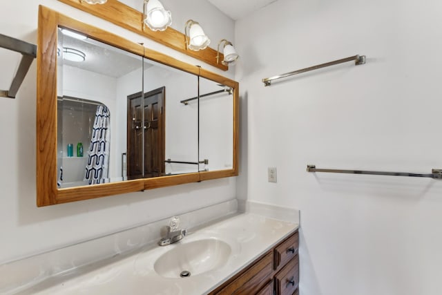 bathroom with walk in shower and vanity