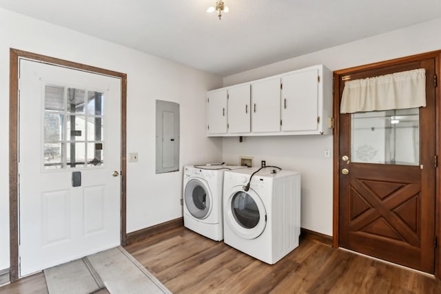 laundry area featuring electric panel, cabinets, washing machine and dryer, and dark hardwood / wood-style flooring