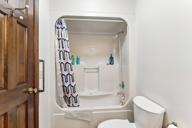 bathroom featuring shower / bath combo and toilet