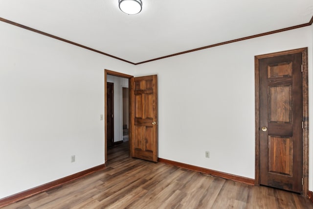 unfurnished room with ornamental molding and hardwood / wood-style floors