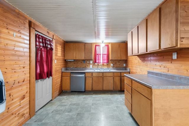 kitchen with wooden walls, sink, and stainless steel dishwasher