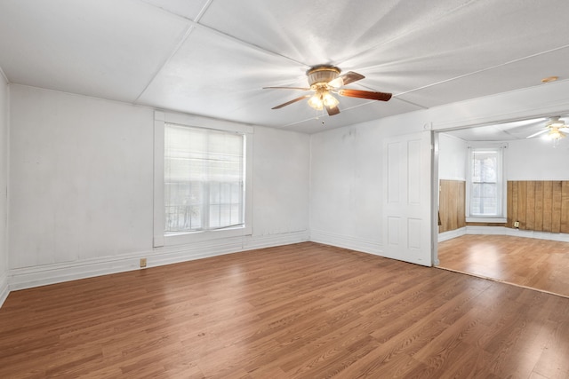 empty room featuring wood-type flooring and ceiling fan