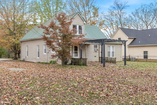 view of front of house featuring a pergola and central AC