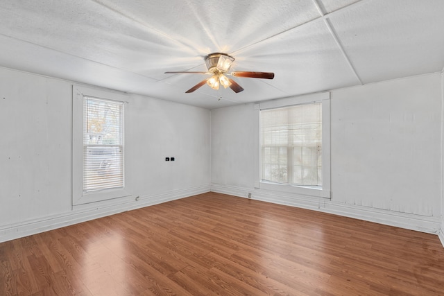 unfurnished room featuring ceiling fan, wood-type flooring, and a textured ceiling