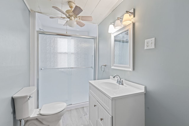 bathroom with toilet, an enclosed shower, crown molding, and vanity