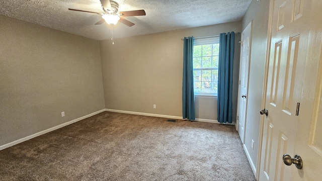 carpeted empty room featuring a textured ceiling and ceiling fan