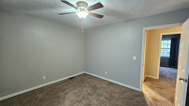 carpeted empty room featuring a textured ceiling and ceiling fan