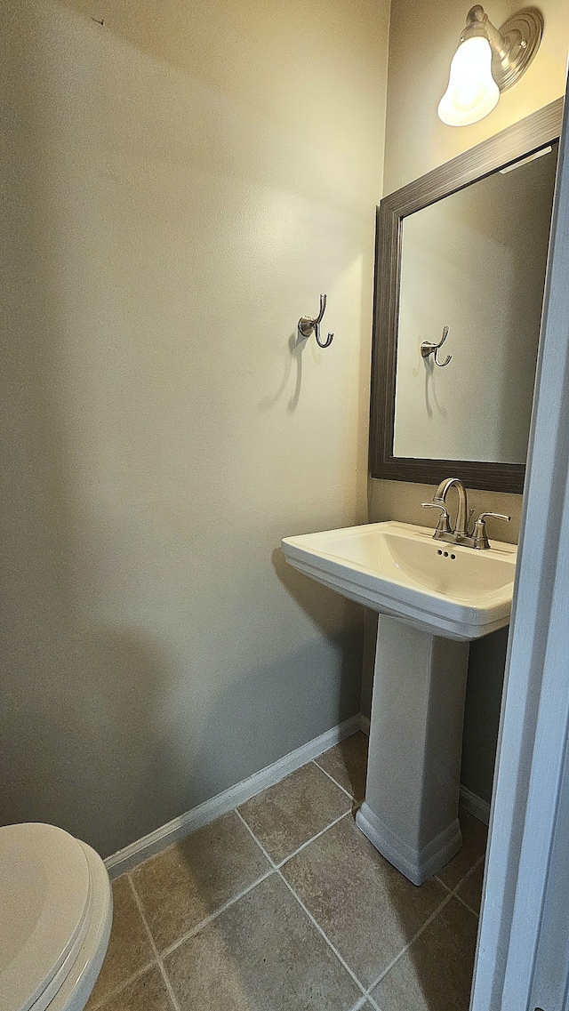 bathroom featuring tile patterned flooring and toilet