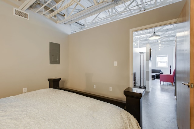 bedroom featuring concrete floors and electric panel