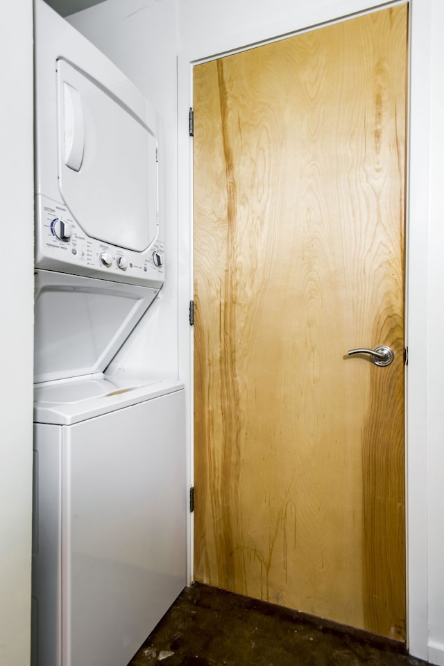 clothes washing area with stacked washer / drying machine